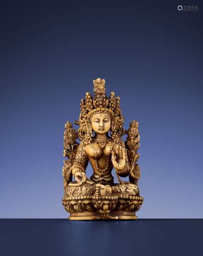 A CARVED IVORY FIGURE OF THE GREEN TARA
