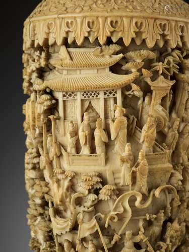 A CARVED AND RETICULATED CANTON IVORY 'MYTHICAL BATTLE' VASE...