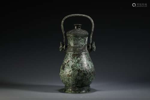 A SHANG ZHOU PERIOD HOOP HANDLE EWER