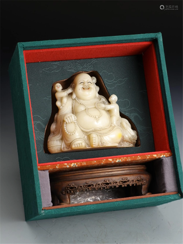 A SOAPSTONE CARVING OF MAITREYA WITH KIDS