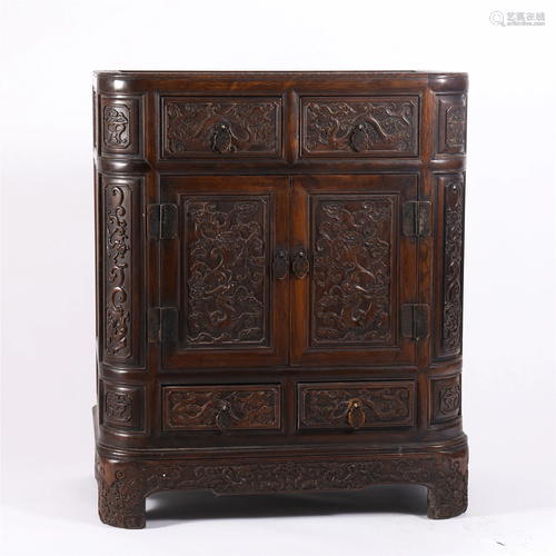 A CARVED HARDWOOD CABINET WITH DRAWERS