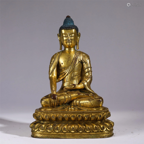 A GILT BRONZE SEATED SAKYAMUNI