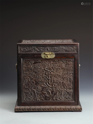 A HARDWOOD LIDDED BOX CARVED WITH PINES