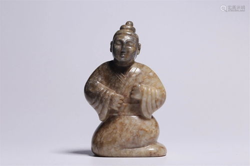 A JADE CARVING OF A KNEELING FIGURE