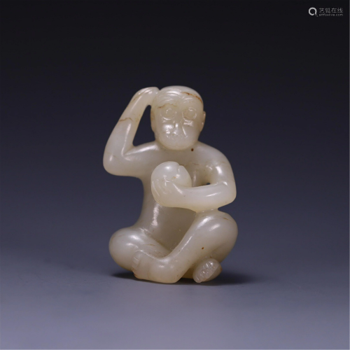 A JADE CARVING OF MONKEY HOLDING A PEACH