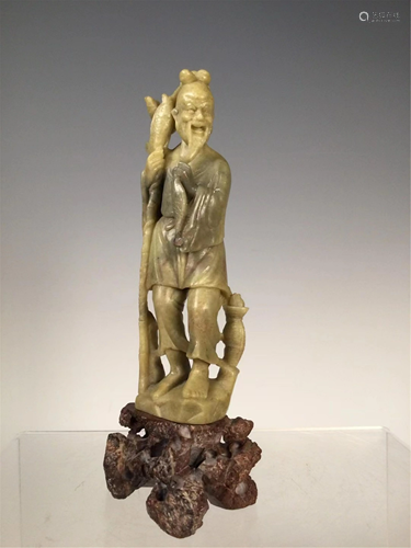 A STONE CARVED FISHERMAN DECORATION