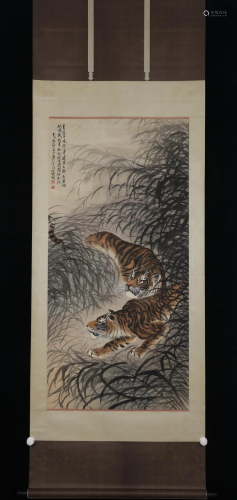 A CHINESE PAINTING OF TWO TIGERS IN THE BUSHES