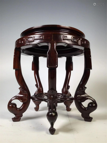 A CARVED HARDWOOD CIRCULAR STAND