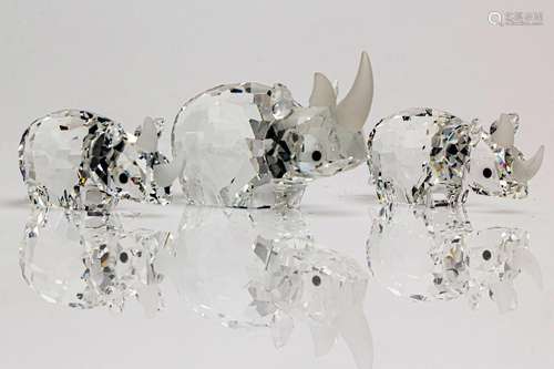 A Swarovski Crystal figure of a Rhinoceros together with two...