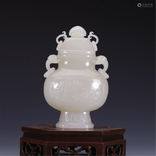 A JADE CARVED DOUBLE-HANDLED VASE WITH COVER