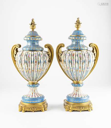 A pair of Sevres style vases and covers with gilt metal moun...