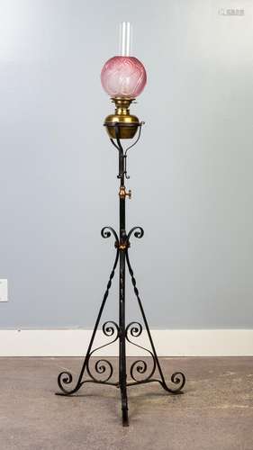 A wrought iron based extending floor copper oil lamp. 66 to ...