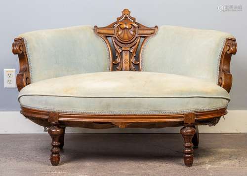 A North American carved walnut framed love seat.