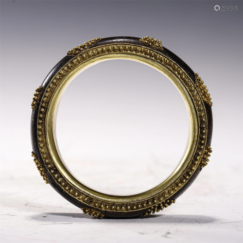 A GILT SILVER MOUNTED CHENXIANG WOOD BANGLE