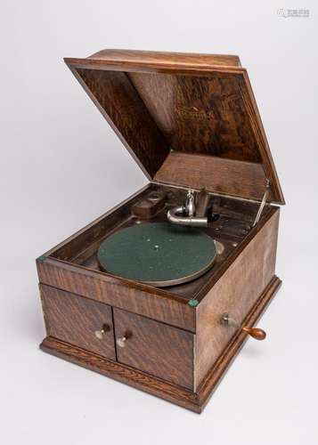 An oak cased Victrola gramophone with built in speaker.