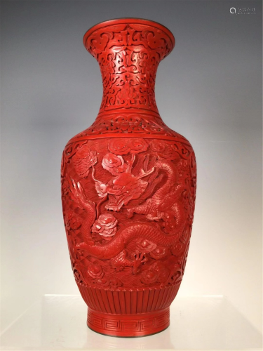 A CARVED RED LACQUER DRAGON VASE