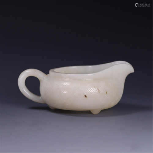 A JADE CARVED TRIPOD CUP WITH A HANDLE