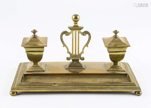 A Victorian brass ink stand with central lyre.