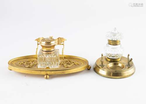 An oval brass inkstand with cut glass inkwell and brass lid,...