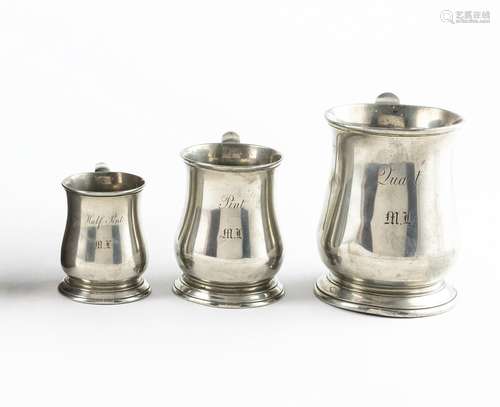 A matched set of three pewter baluster form tankards. Mugs 3...