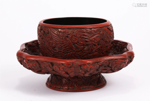 A CARVED RED LACQUER PHOENIX CUP AND SAUCER