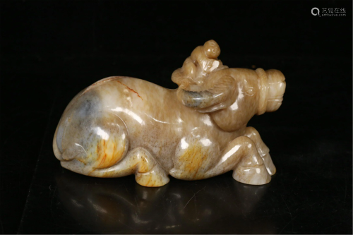 A CARVED 'KID AND BUFFALO' DECORATION