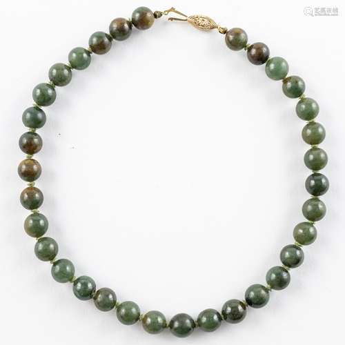 A Chinese dark green jadeite beaded necklace,