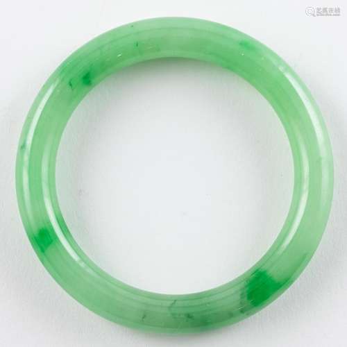 A Chinese green jadeite bangle. 3 in. (7.6 cm) d.