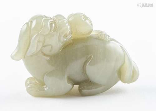 A celadon jadeite carving of a boy hugging a foo dog.