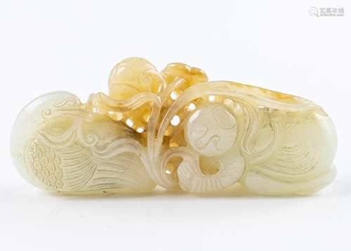 A brown and white jadeite carving of a boy playing with a sw...