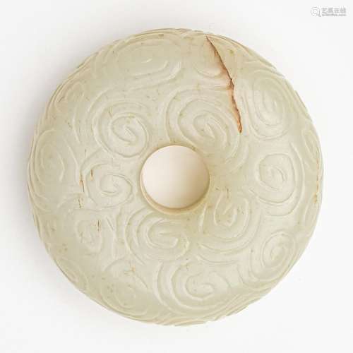 A Chinese light celadon jadeite bi-disc, 2 1/4 in. (6 cm)