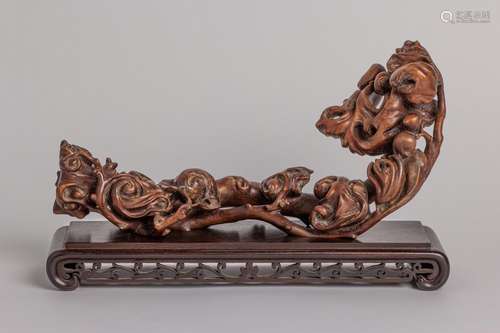 A carved wood ruyi sceptre with scrolling foliage, 13 in. (3...