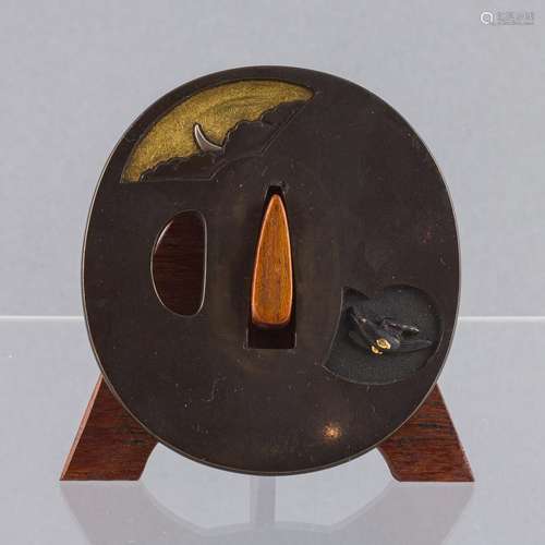 An 18th century Japanese bronze shibuichi tsuba, 2 11/16 x 2...