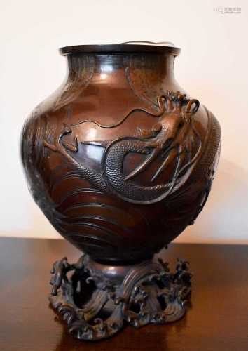 A early 19th century Chinese bronze vase, cast with a wrythe...