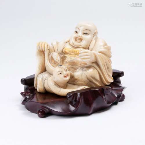 A Figure of Seated Budai with Child.