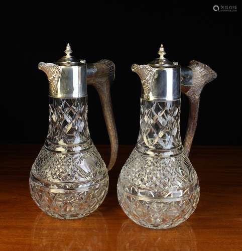 A Pair of Cut Glass Claret Jugs with antler handles and silv...