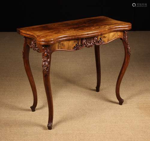 A Fine Victorian Carved Walnut Fold-over Tea Table.