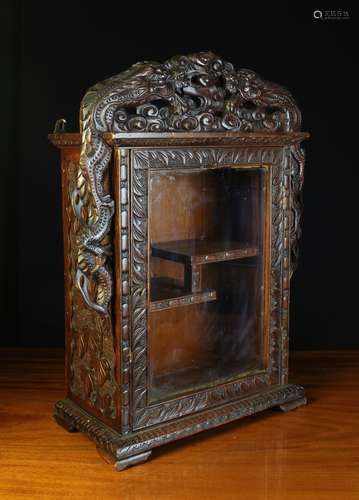 A Small Oriental Lacquered Cabinet having a glazed door with...