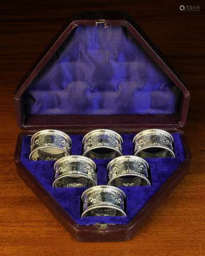 A Set of Six Decorative Silver Plated Napkin Rings set in a ...