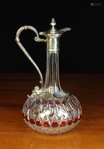 A Cut Glass Claret Jug in Silver Plated Mounts.