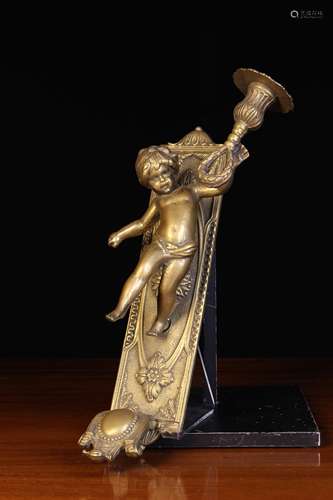 A Cast Brass Figural Candle Holder.