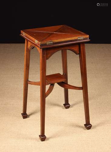 An Edwardian Mahogany Envelope Table inlaid with stringing.