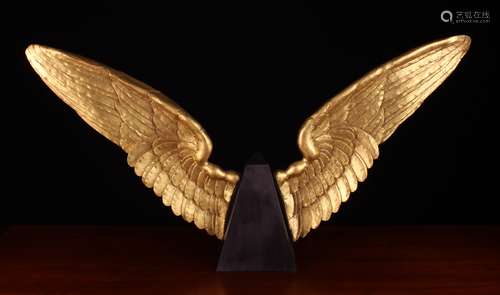 A Pair of Carved Giltwood Angel Wings, mounted either side o...