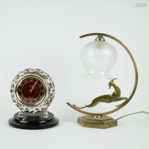 An Art Deco lampadaire with antelope and a Russian alarm clo...