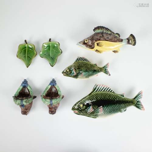 A collection of ornamental glazed pottery, bulls, fish leave...