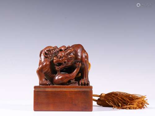 A QING DYNASTY SANDALWOOD BEAST BUTTON SEAL