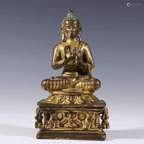 A YUAN DYNASTY BRONZE GILDING BUDDHA STATUE