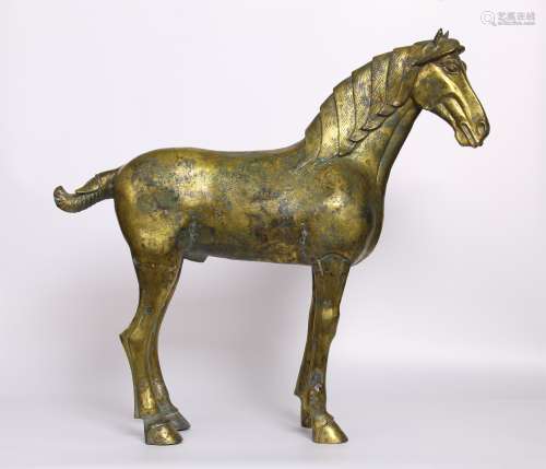 A TANG DYNASTY BRONZE GILDED HORSE