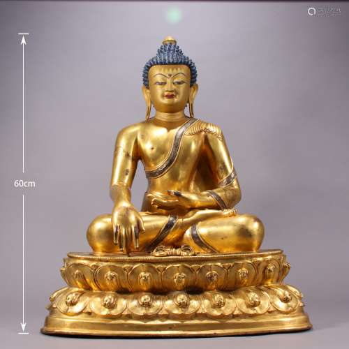 A MING DYNASTY BRONZE GILDING SAKYAMUNI STATUE