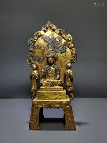 A NORTHERN WEI QINGZHOU BRONZE GILDED BENCH BUDDHA